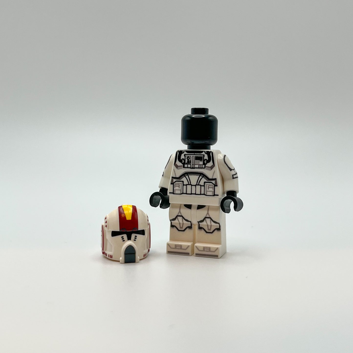 Custom pilot Oddball with Clone Army Customs helmet on ground next to minifig